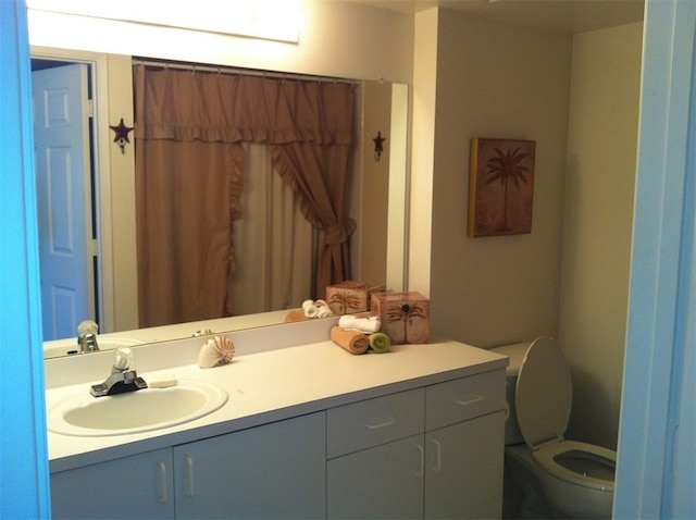 bathroom featuring toilet and vanity