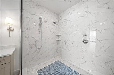 225 Strand Dr Unit 204, Melbourne Beach, FL 32951 - bathroom with vanity and a marble finish shower
