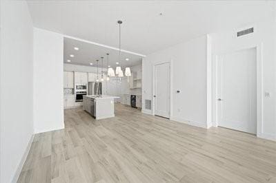 225 Strand Dr Unit 204, Melbourne Beach, FL 32951 - unfurnished living room with light wood-style floors