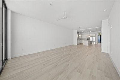 225 Strand Dr Unit 204, Melbourne Beach, FL 32951 - unfurnished living room featuring light wood-style flooring and a chandelier