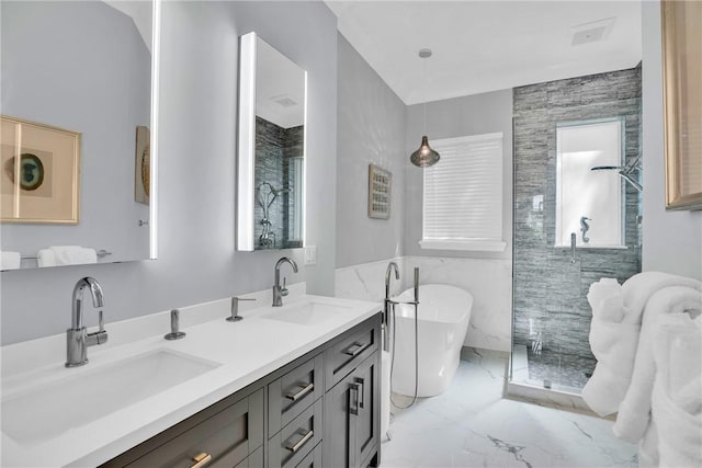 bathroom with marble finish floor, a sink, a shower stall, and double vanity