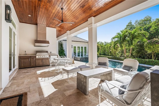 view of patio featuring ceiling fan, an outdoor kitchen, and grilling area