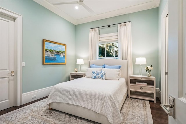 bedroom with crown molding, ceiling fan, and dark hardwood / wood-style floors