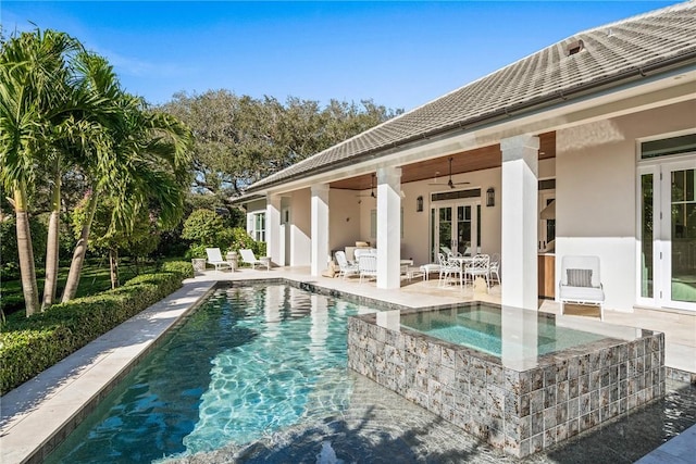 view of swimming pool featuring an in ground hot tub, ceiling fan, and a patio