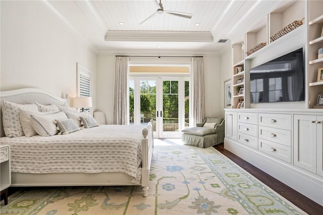 bedroom featuring crown molding, a tray ceiling, french doors, and access to outside