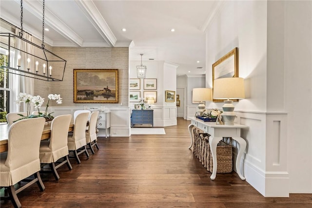 dining space featuring hardwood / wood-style floors, crown molding, and a chandelier