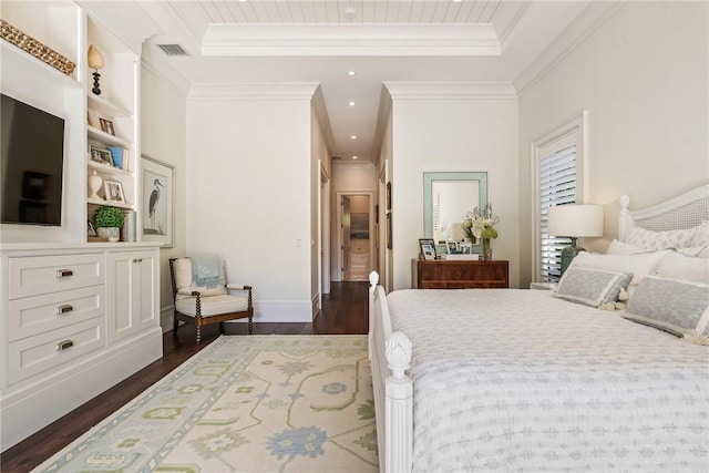 bedroom featuring dark hardwood / wood-style flooring, ornamental molding, and a raised ceiling