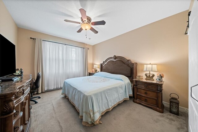 bedroom featuring light colored carpet and ceiling fan