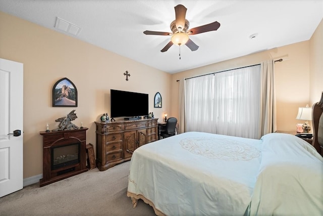 bedroom with light carpet and ceiling fan