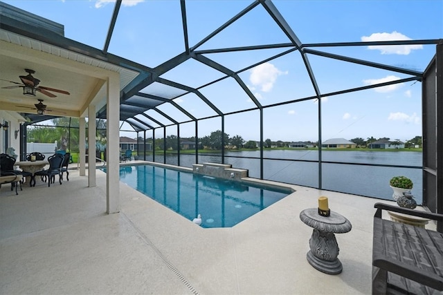 view of swimming pool with a water view, ceiling fan, a patio, pool water feature, and a lanai