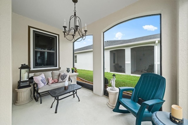 sunroom / solarium with a notable chandelier