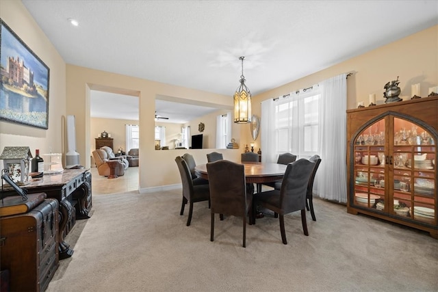 dining area featuring light carpet