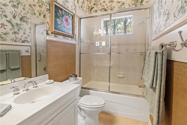 bathroom featuring wallpapered walls, tile patterned floors, vanity, and wainscoting
