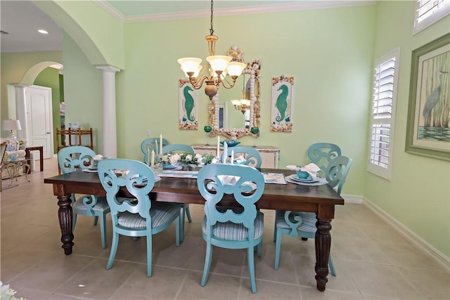 dining space with baseboards, tile patterned flooring, arched walkways, and crown molding