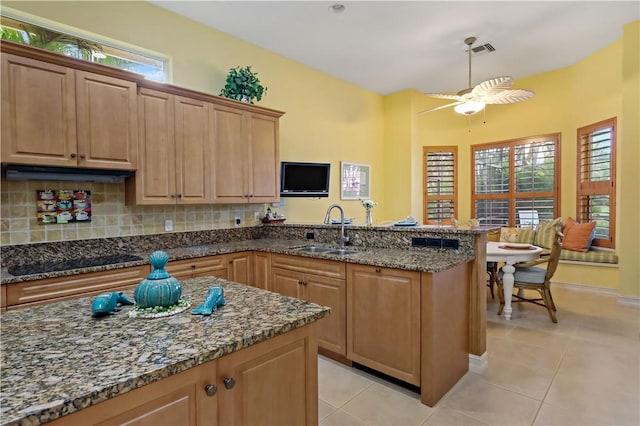 kitchen with a wealth of natural light, visible vents, black electric cooktop, and a sink