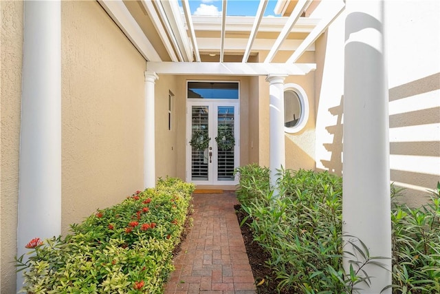 property entrance with french doors and stucco siding