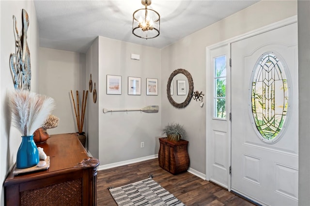 entrance foyer with dark hardwood / wood-style floors and a chandelier