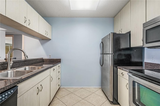 5 Plantation Dr Unit 206, Vero Beach, FL 32966 - kitchen with stainless steel appliances, light tile patterned flooring, a textured ceiling, and dark stone counters