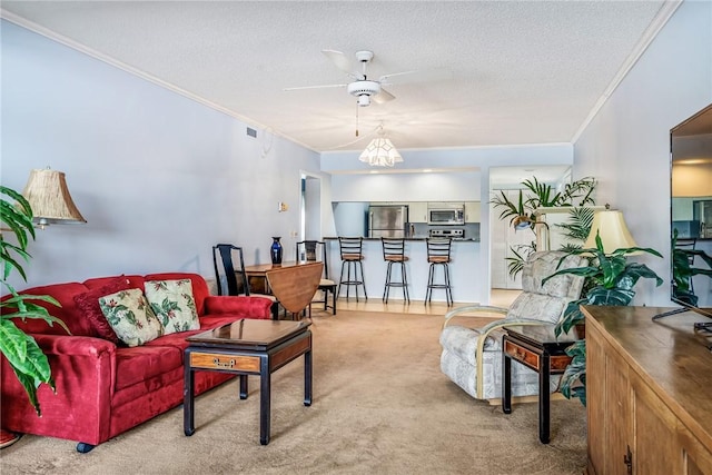 5 Plantation Dr Unit 206, Vero Beach, FL 32966 - carpeted living room featuring crown molding, a ceiling fan, and a textured ceiling