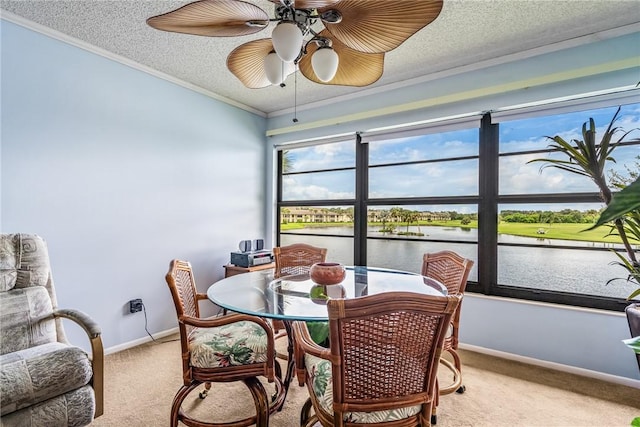 5 Plantation Dr Unit 206, Vero Beach, FL 32966 - dining area with light carpet, a water view, ornamental molding, a textured ceiling, and ceiling fan