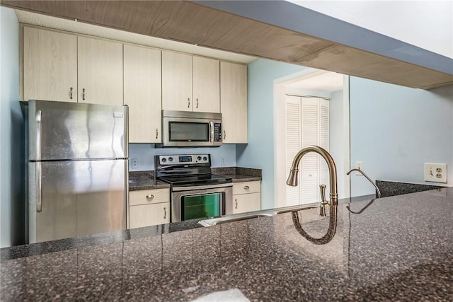 5 Plantation Dr Unit 206, Vero Beach, FL 32966 - kitchen with appliances with stainless steel finishes and dark stone countertops
