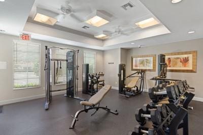 5582 49th Ave, Vero Beach, FL 32967 - exercise room featuring a raised ceiling, baseboards, and plenty of natural light