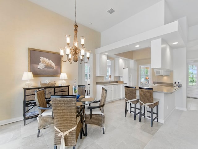 dining area with sink and a notable chandelier