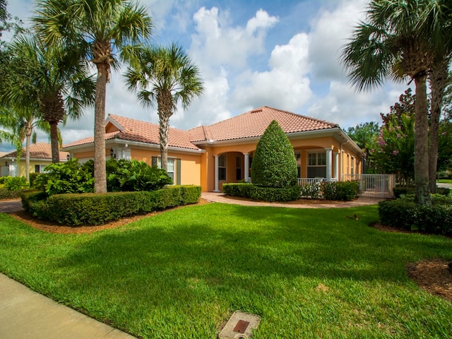 mediterranean / spanish-style home with a front lawn