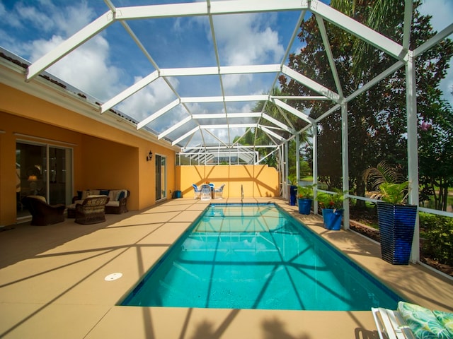 view of swimming pool with an outdoor hangout area, a patio area, and a lanai