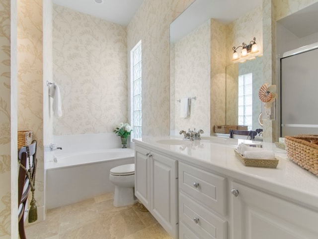 full bathroom with vanity, shower with separate bathtub, and toilet