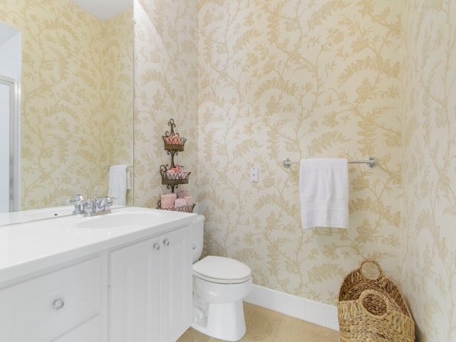 bathroom featuring tile patterned floors, toilet, and vanity