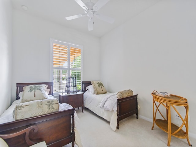 bedroom featuring ceiling fan and light carpet