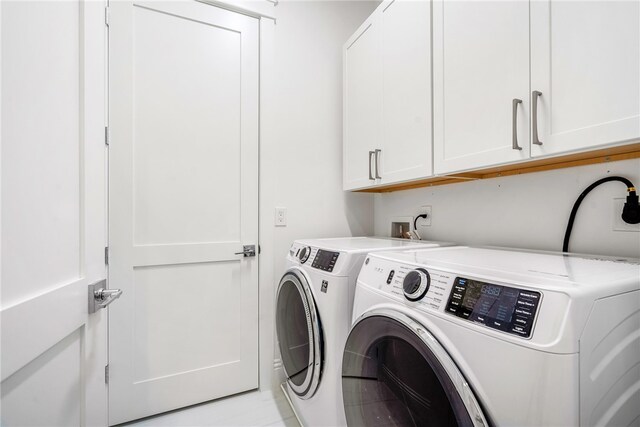 laundry area featuring cabinets and separate washer and dryer