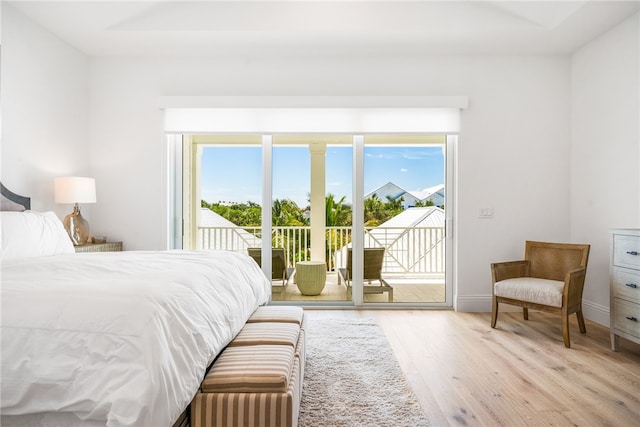 bedroom with access to outside and light hardwood / wood-style floors