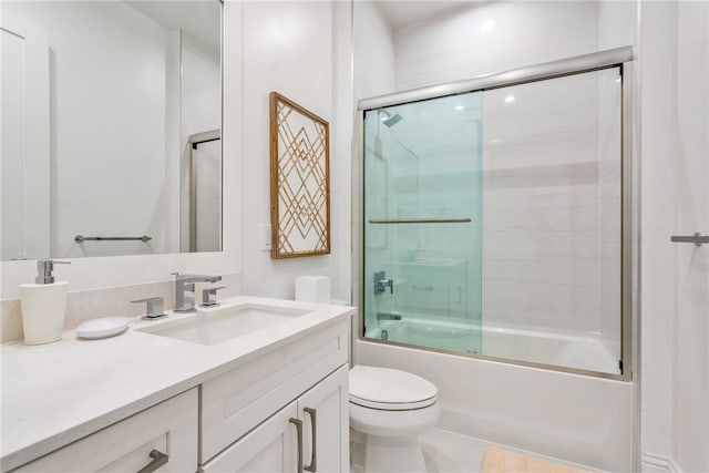 full bathroom with bath / shower combo with glass door, vanity, toilet, and tile patterned floors