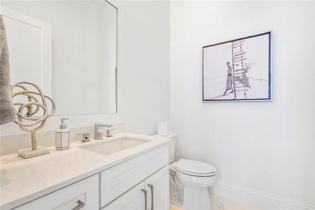 bathroom featuring tile patterned flooring, vanity, and toilet