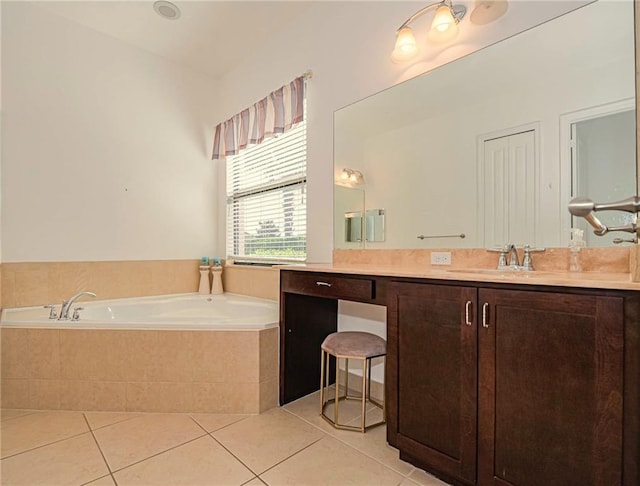 bathroom with tiled bath, tile patterned floors, and vanity