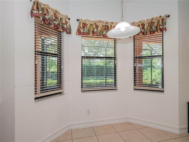 unfurnished room featuring a wealth of natural light and light tile patterned floors