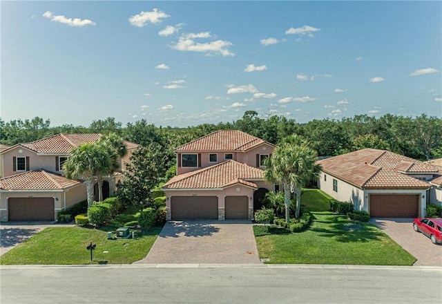 mediterranean / spanish-style home featuring a front yard and a garage