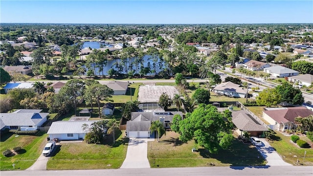 drone / aerial view with a residential view and a water view