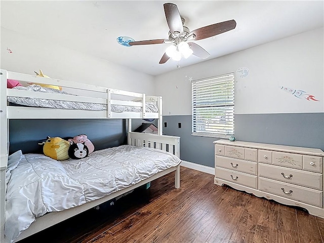 bedroom featuring baseboards, dark wood-type flooring, and ceiling fan