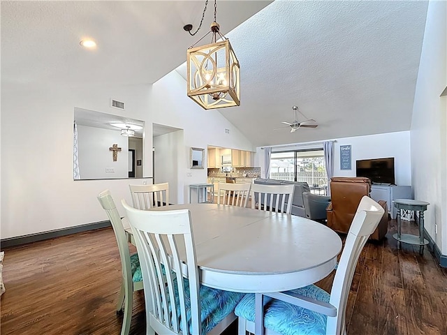 dining area featuring wood finished floors, ceiling fan with notable chandelier, visible vents, and a textured ceiling