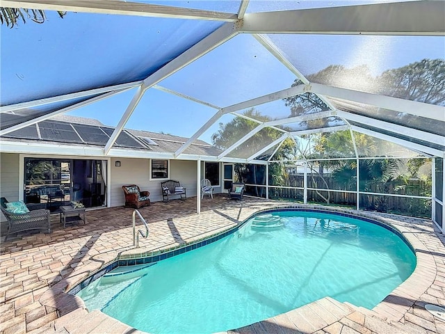 outdoor pool featuring a patio area and glass enclosure