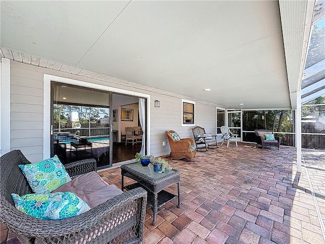 view of patio featuring an outdoor living space and glass enclosure