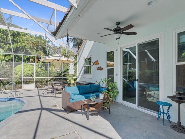 view of patio / terrace with glass enclosure, ceiling fan, and an outdoor living space