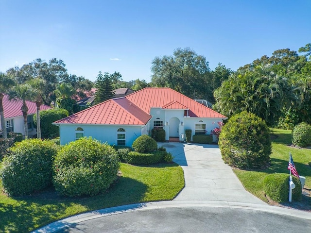 mediterranean / spanish-style house featuring a front yard