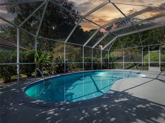 view of swimming pool with a patio and a lanai