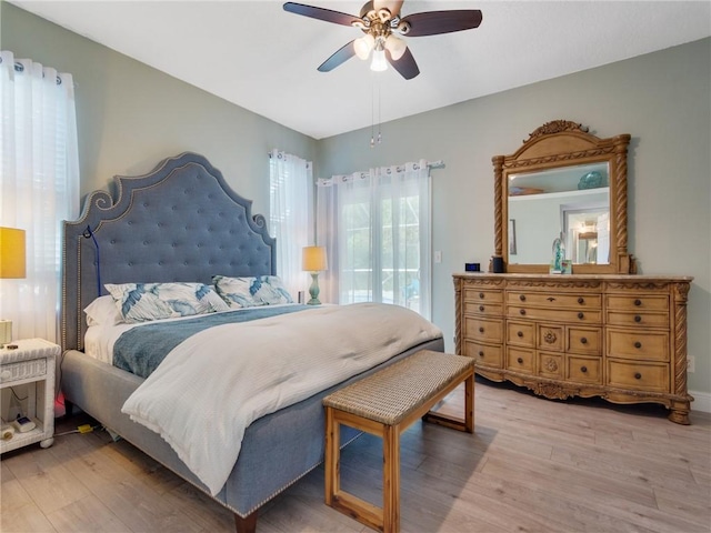 bedroom featuring access to exterior, ceiling fan, and hardwood / wood-style flooring