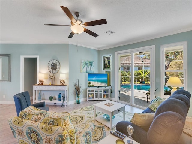 living room featuring ceiling fan, light hardwood / wood-style floors, and crown molding