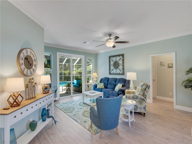 living room featuring ceiling fan, crown molding, and light hardwood / wood-style floors